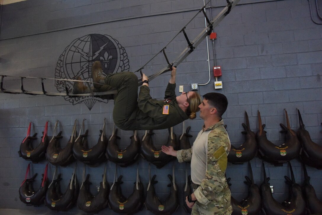 Tech. Sgt. Timothy, 352nd Battlefield Airmen Training Squadron instructor supervisor, spots Cadet Madeline Kirkpatrick, Troy University student, as she climbs a caving ladder at Matero Hall during Pathways to Blue April 7, 2017, on Keesler Air Force Base, Miss. Pathways to Blue, a diversity outreach event hosted by 2nd Air Force, provides cadets briefings on technical and flying operations and an orientation flight in support of the Air Force's Diversity Strategic Roadmap program. (U.S. Air Force photo by Kemberly Groue)