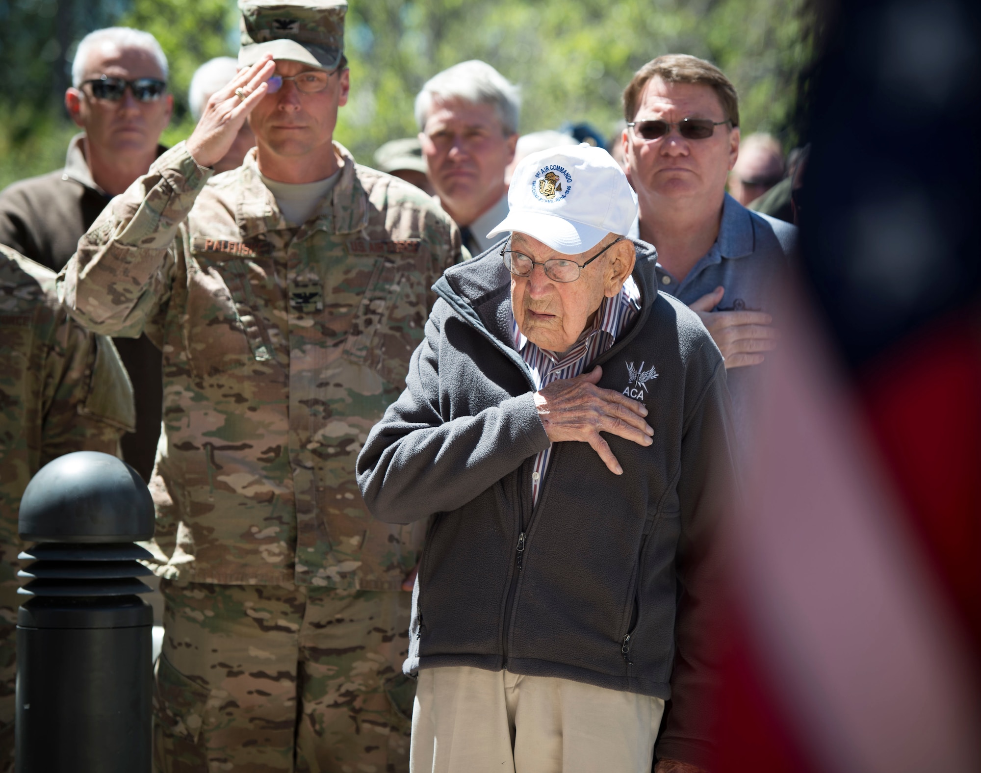 Retired Lt. Col. Richard E. Cole stands for the national anthem during a building renaming and dedication ceremony at Hurlburt Field, Fla., April 7, 2017.  The 319th Special Operations Squadron building was renamed after Cole in honor of his career as an early Air Commando and Doolittle Raider. (U.S. Air Force photo by Senior Airman Krystal M. Garret)