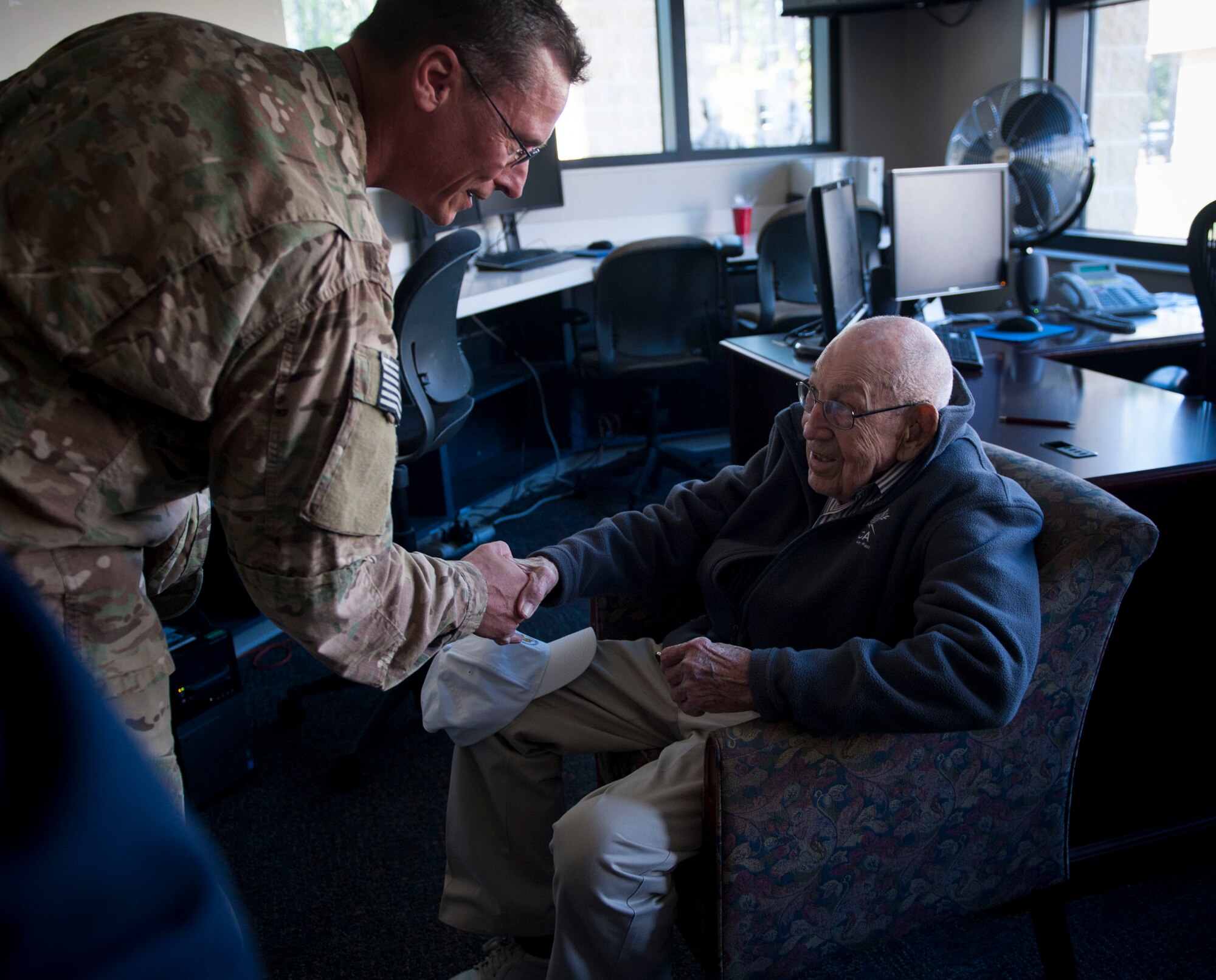 Col. Tom Palenske, the commander of the 1st Special Operations Wing, gives retired Lt. Col. Richard E. Cole, his commander’s coin after a building renaming and dedication ceremony at Hurlburt Field, Fla., April 7, 2017. Cole retired from active duty with a list of accomplishments and awards that includes: the Distinguished Flying Cross with two oak leaf clusters, the Bronze Star medal, the Air Force Commendation medal, the Chinese Army, Navy, Air Corps medal, Class A, 1st Grade. On May 23, 2014, President Barrack H. Obama issued the Congressional Gold Medal to Cole along with three other living Doolittle Raiders at the White House. (U.S. Air Force photo by Senior Airman Krystal M. Garrett)