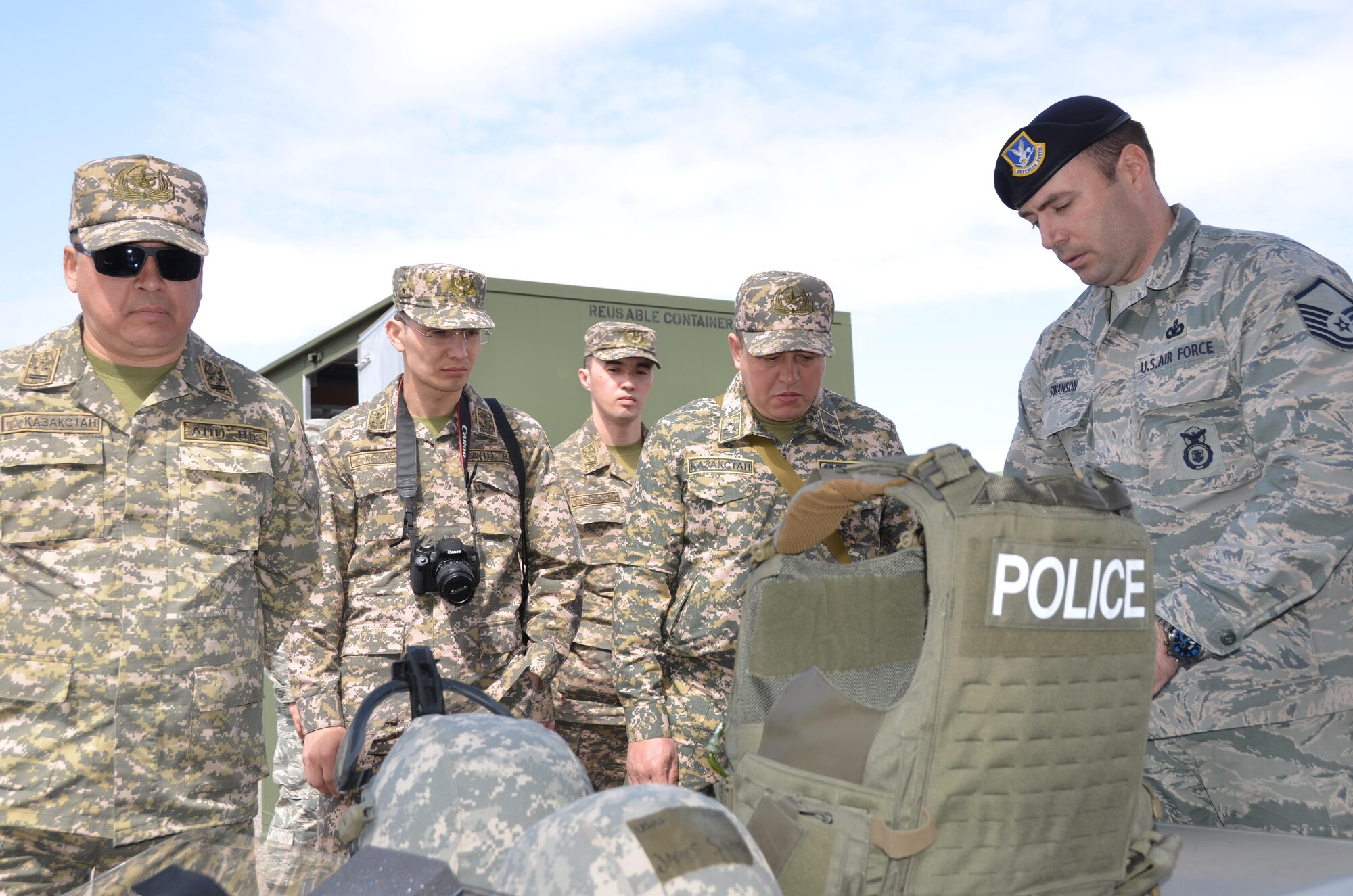 Air Force Master Sgt. James Swanson (right), security forces operations superintendent for the 161st Security Forces Squadron, shows a delegation of Kazakh military officers law enforcement gear during a tour of Goldwater Air National Guard Base. The Arizona Air National Guard hosted the officers, March 31, as part of the National Guard's State Partnership Program. (U.S. Air National Guard photo by 2nd Lt. Tinashe Machona).