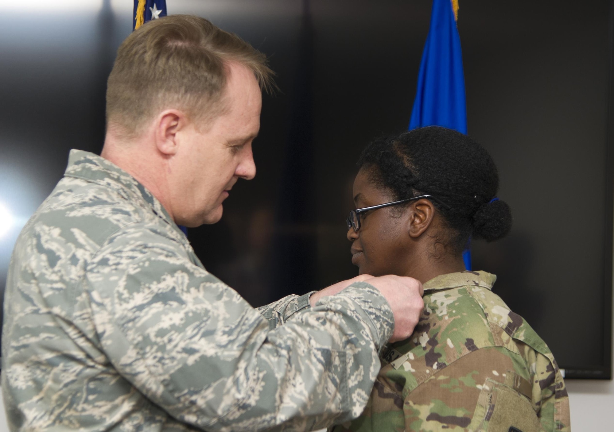 U.S. Air Force Col. Daniel Knight, 673d Mission Support Group commander, pins an Air Force commendation medal to Army Sgt. 1st. Class Ashly McBunch during a ceremony at Joint Base Elmendorf-Richardson, Alaska, March 31, 2017. 