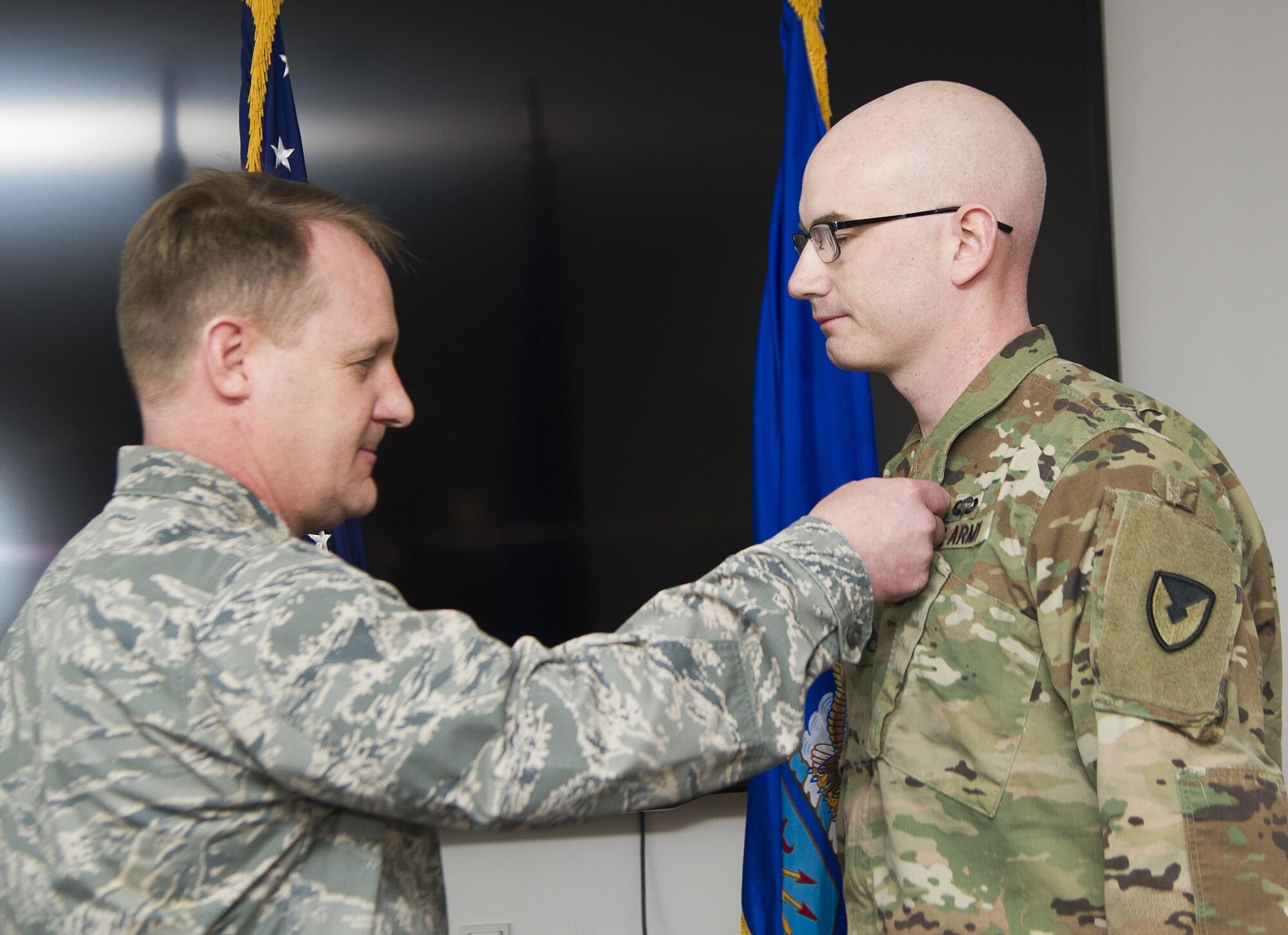 Col. Daniel Knight, left, 673d Mission Support Group commander, pins an Air Force Commendation Medal to Army Staff Sgt. Mark Fitzgerald during ceremony at Joint Base Elmendorf-Richardson, Alaska, March 31, 2017. While assigned to the 673d Contracting Squadron, Fitzgerald executed eight contracts valued at $389,000 supporting more than 1,500 joint warfighter and 400 Federal Emergency Management Agency responders for Exercise Alaska Shield 2014. 