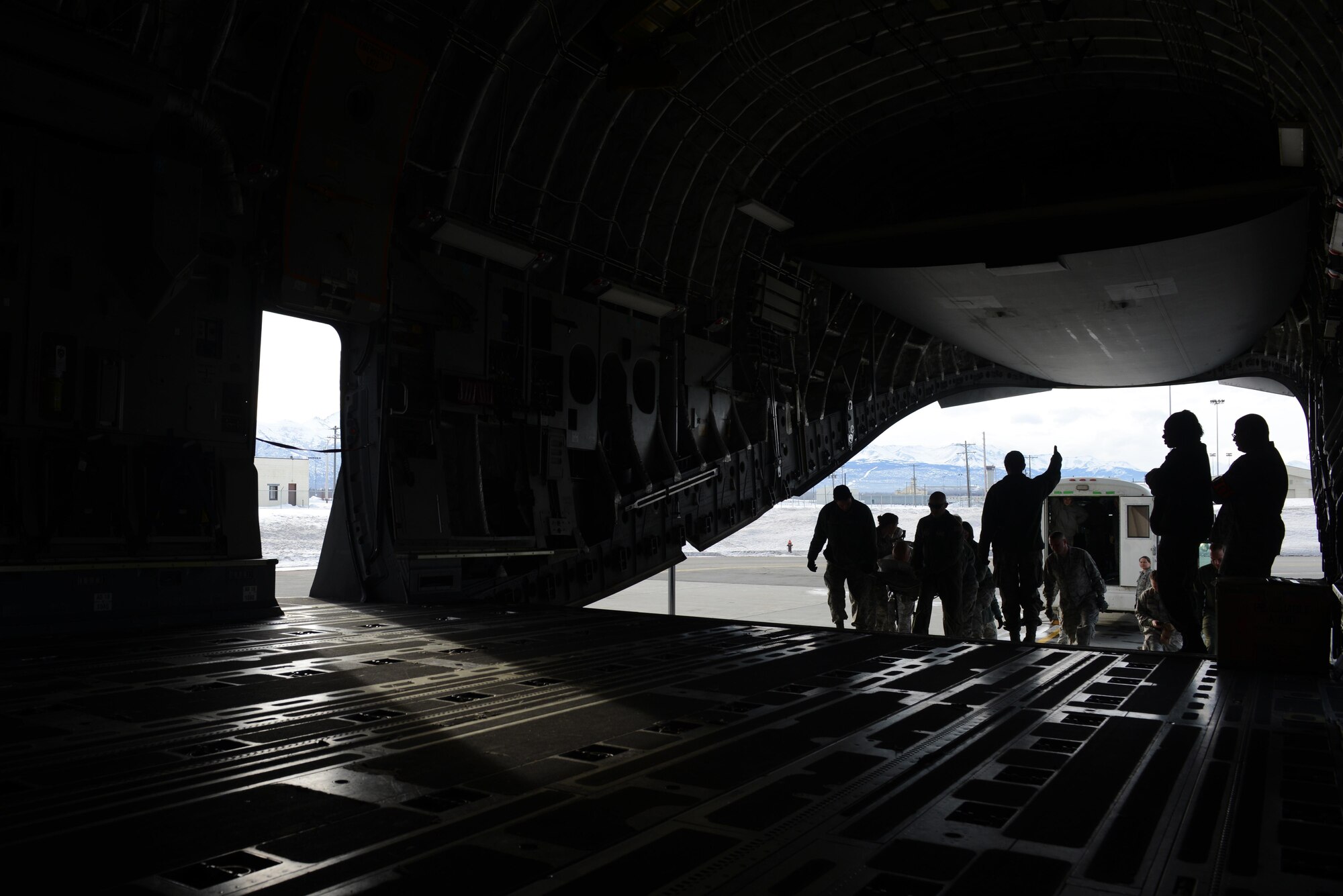 673d Medical Group Airmen transport a simulated patient from a bus into a C-17 Globemaster III during the EnRoute Patient Staging System exercise at Joint Base Elmendorf-Richardson, Alaska, April 3, 2017. The ERPSS provides patient reception and limited emergent intervention, and ensures patients are medically and administratively prepared for flight in a safe and timely aeromedical evacuation. 