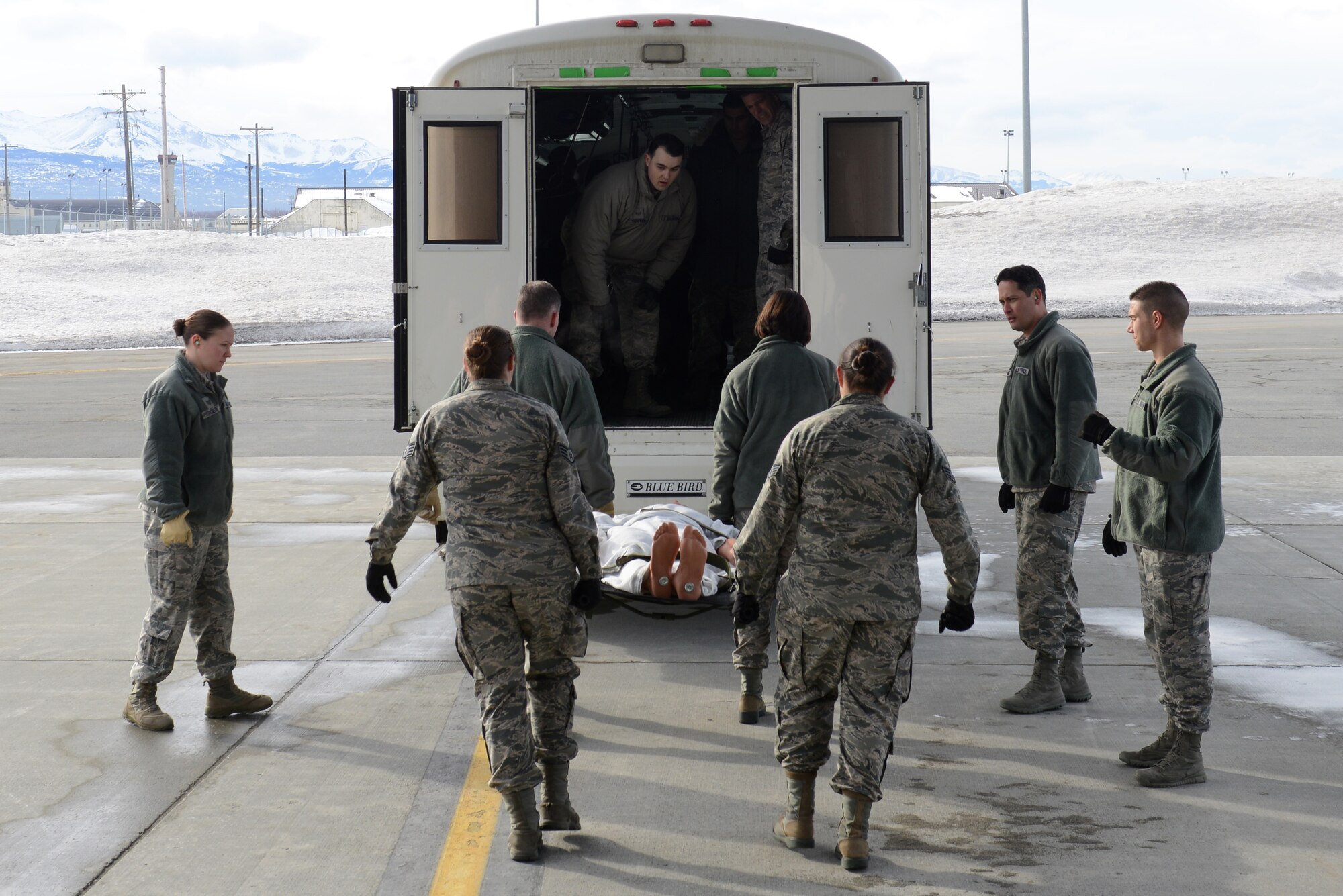 673d Medical Group Airmen transport a simulated patient from a C-17 Globemaster III into a bus during the EnRoute Patient Staging System exercise at Joint Base Elmendorf-Richardson, Alaska, April 3, 2017. The ERPSS provides patient reception and limited emergent intervention, and ensures patients are medically and administratively prepared for flight in a safe and timely aeromedical evacuation. 