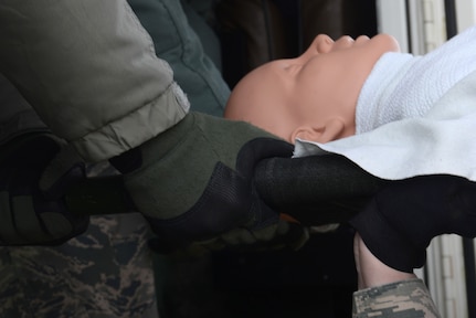 673d Medical Group Airmen transport a simulated patient from a C-17 Globemaster III into a bus during the EnRoute Patient Staging System exercise at Joint Base Elmendorf-Richardson, Alaska, April 3, 2017. The ERPSS provides patient reception and limited emergent intervention, and ensures patients are medically and administratively prepared for flight in a safe and timely aeromedical evacuation. 