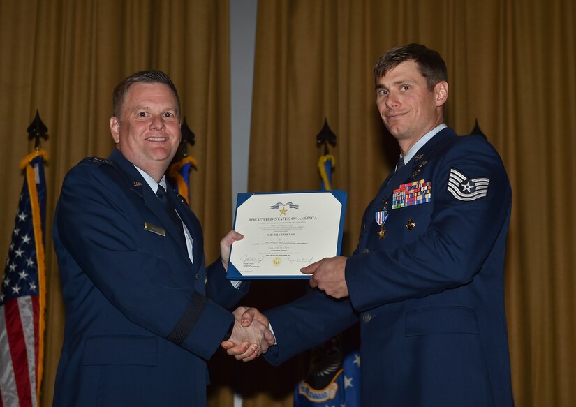 Lt. Gen. Brad Webb, commander of Air Force Special Operations Command, presents Tech. Sgt. Brian Claughsey, a combat controller with the 21st Special Tactics Squadron, a Silver Star Medal, April 7, 2017, at Pope Army Airfield, N.C. Following a 96-hour battle with Taliban forces in Afghanistan, Claughsey was credited with coordinating 17 close air engagements, resulting in 47 enemy killed in action without a single civilian or friendly casualty. (U.S. Air Force photo by Senior Airman Ryan Conroy)
