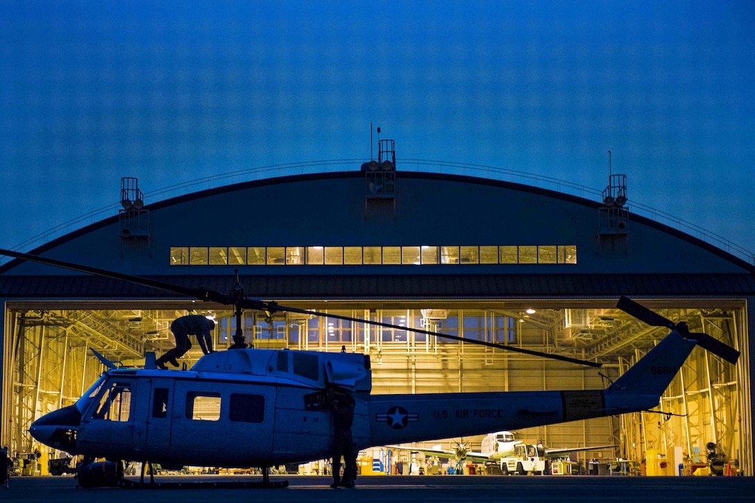 The crew of a UH-1N Iroquois helicopter performs preflight checks before hoist training at night at Yokota Air Base, Japan, April 4, 2017. Air Force photo by Airman 1st Class Donald Hudson