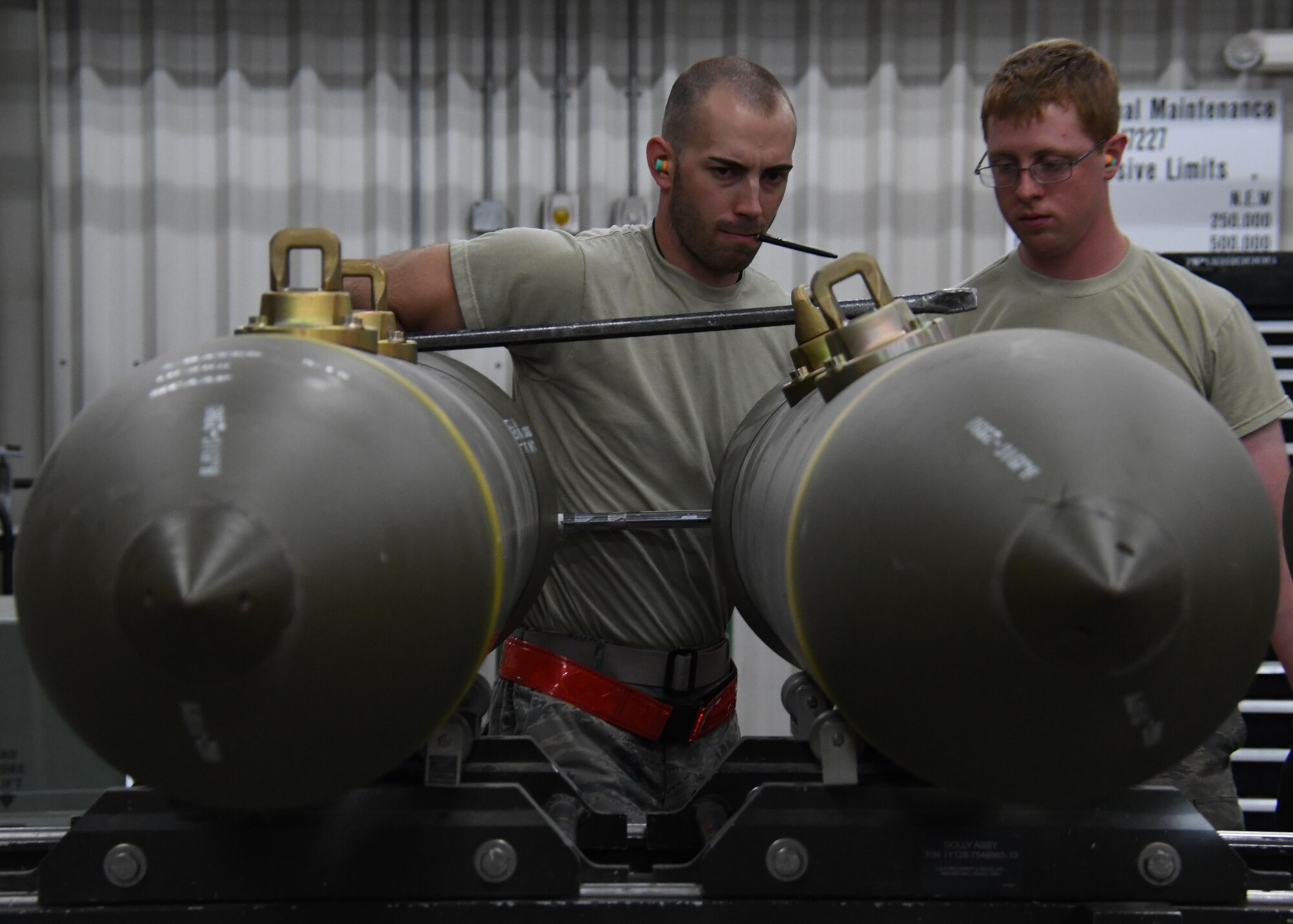 U.S. Air Force Airman 1st Class Joshua Despain, left, and Senior Airman Alex Caton, both ammo Airmen with the 379th Expeditionary Maintenance Squadron, install and torque the fuse on a guided bomb unit-31 at Al Udeid Air Base, Qatar, April 6, 2017. Ammo Airmen are responsible for assembling bombs and munitions, and must do so with the greatest attention to detail, or risk a malfunction or misfire with the bombs. (U.S. Air Force photo by Staff Sergeant Miles Wilson)