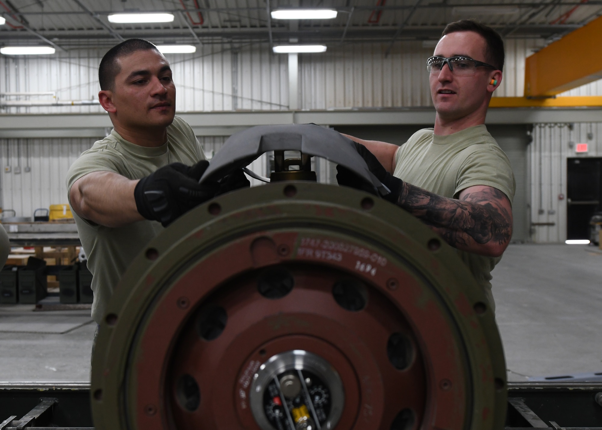 U.S. Air Force Airman 1st Class Austin Blom, left, and Staff Sgt. Woodrow Short, both ammo Airmen with the 379th Expeditionary Maintenance Squadron, attach a hardback installation to a guided bomb unit-31 at Al Udeid Air Base, Qatar, April 6, 2017. The ammo Airmen ensure that the bombs built at Al Udeid are safe and working properly through their diligent work and attentiveness to detail. (U.S. Air Force photo by Staff Sergeant Miles Wilson)