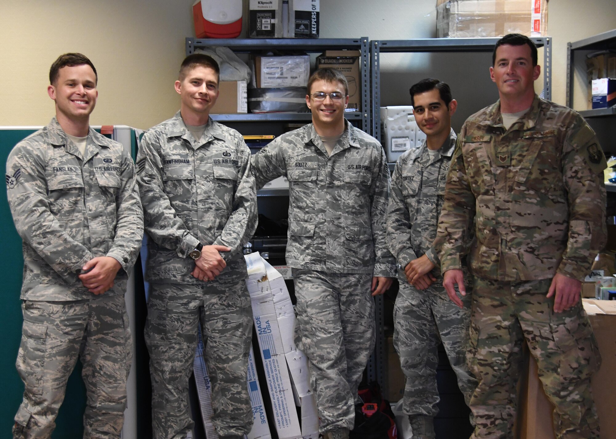 The 379th Expeditionary Contracting Squadron Commodities Flight poses for a group photo at Al Udeid Air Base, Qatar, April 5, 2017. The commodities flight improves mission capability and also brings the comforts of home to a deployed environment by procuring items and services such as flight equipment and wireless internet. (U.S. Air Force photo by Senior Airman Miles Wilson)