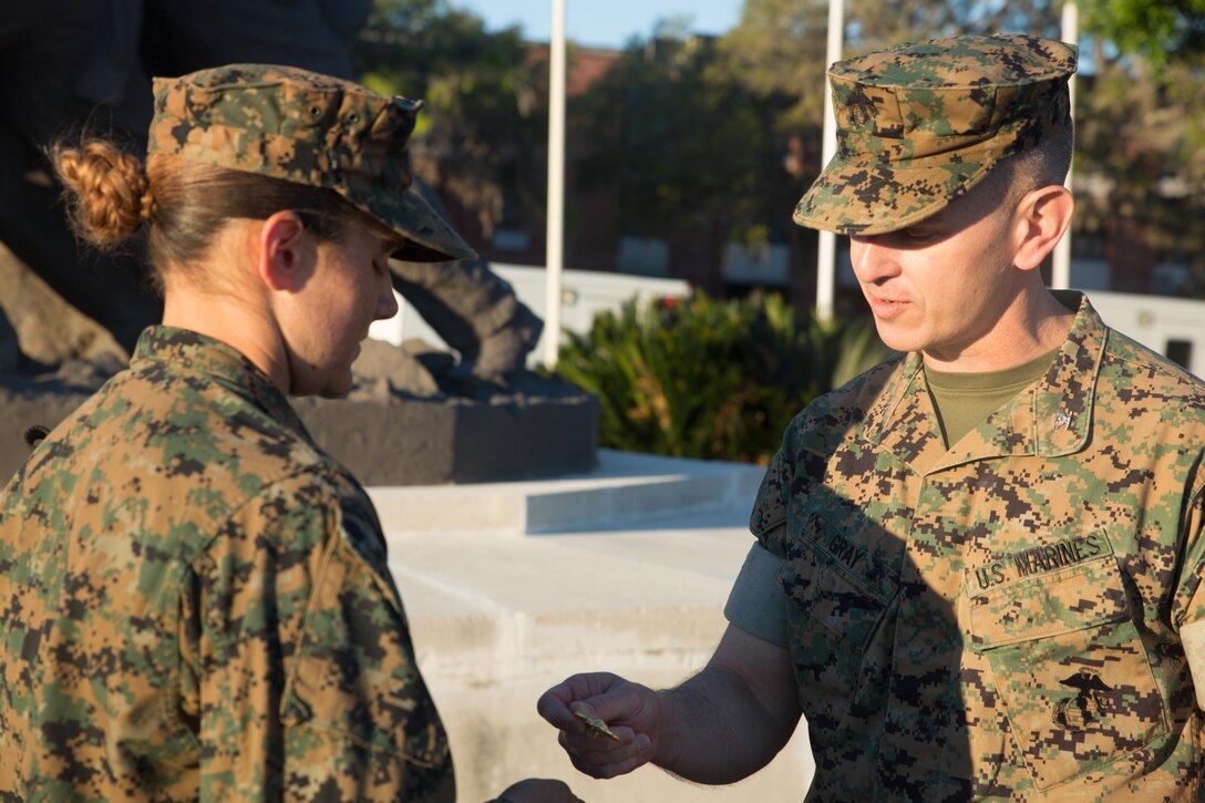 Col. William C. Gray, assistant chief of staff for operations at the Marine Corps Recruiting Command, presents an Eagle, Globe and Anchor emblem to his niece, Pvt. Mckenzie I. Holmes, Platoon 4012, Oscar Company, 4th Recruit Training Battalion, at Marine Corps Recruit Depot Parris Island, S.C., April 8, 2017. The emblem is earned only by those who are imbued with the Corps’ core values and have proven themselves worthy of the title Marine. Parris Island has been the site of Marine Corps recruit training since Nov. 1, 1915. Today, approximately 19,000 recruits come to Parris Island annually for the chance to become United States Marines by enduring 12 weeks of rigorous, transformative training. Parris Island is home to entry-level enlisted training for 49 percent of male recruits and 100 percent of female recruits in the Marine Corps. (Photo by Lance Cpl. Maximiliano Bavastro)