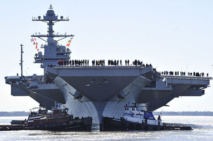 Sailors aboard the aircraft carrier Pre-Commissioning Unit (PCU) Gerald R. Ford (CVN 78) man the rails as the ship departs Huntington Ingalls Industries Newport News Shipbuilding for builder's sea trials off the U.S. East Coast. The first-of-class ship-the first new U.S. aircraft carrier design in 40 years-will spend several days conducting builder's sea trials, a comprehensive test of many of the ship's key systems and technologies. 