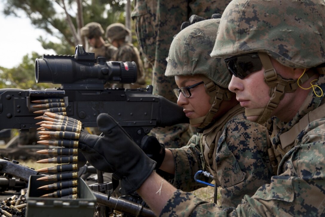 Lance Cpl. Nautika Jordan, left, an electrician, and Lance Cpl. Liam Turner, a bulk fuel specialist with Combat Logistics Battalion 31, 31st Marine Expeditionary Unit, fire an M240G medium machine gun at Camp Hansen, Okinawa, Japan, Feb. 16, 2017. The Marines conducted the live fire range to re-qualify on the weapon system. As the Marine Corps' only continuously forward deployed unit, the 31st MEU air-ground-logistics team provides a flexible force, ready to perform a wide range of military operations, from limited combat to humanitarian assistance operations, throughout the Indo-Asia Pacific region. (U.S. Marine Corps photo by Lance Cpl. Amy Phan/Released) 