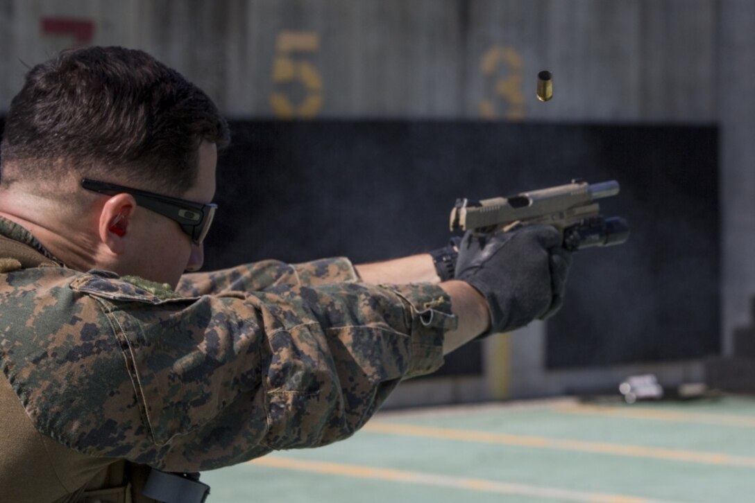 A Marine with the 31st Marine Expeditionary Unit, fires a M45A1 pistol at a range on Camp Hansen, Okinawa, Japan, Feb. 27, 2017. As the Marine Corps' only continuously forward-deployed unit, the 31st Marine Expeditionary Unit's air-ground-logistics team range of military operations, from limited combat to humanitarian assistance operations, throughout the Indo-Asia-Pacific region. (U.S. Marine Corps photo by Cpl. Jona R. Meme/Released) 