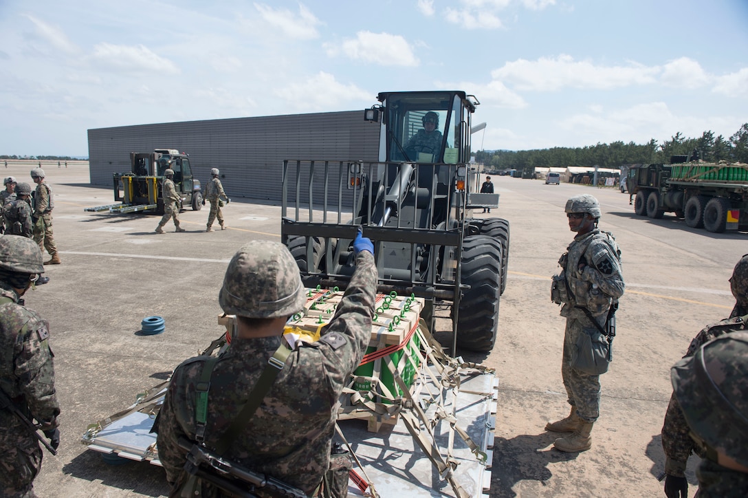U.S. Air Force Staff Sgt. Matthew Blair (inside forklift), an aerial porter assigned to the 621st Contingency Response Wing stationed at Joint Base McGuire-Dix-Lakehurst, N.J., is given a thumbs up by a Republic of Korea Air Force Airman after successfully directing Blair place cargo on the ground as they conduct combined training during exercise Turbo Distribution 17-3, at Pohang Air Base, Republic of Korea, April 10, 2017. (U.S. Air Force photo by Tech. Sgt. Gustavo Gonzalez/RELEASED)