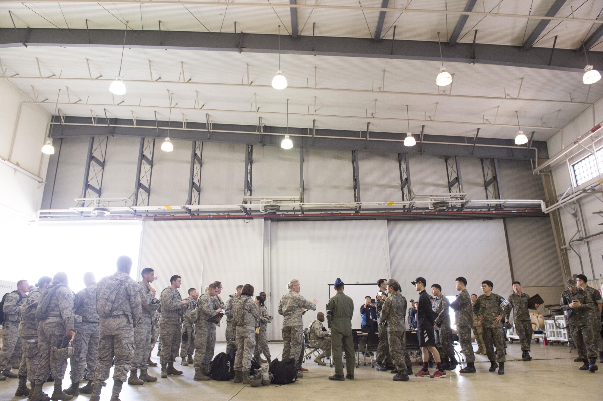 U.S. Air Force Airmen assigned to the 621st Contingency Response Wing stationed at Joint Base McGuire-Dix-Lakehurst, N.J., and U.S. Army Soldiers assigned to the 689th Rapid Port Opening Element stationed at Joint Base Langley-Eustis, Va., combine with Republic of Korea Air Force Airmen during exercise Turbo Distribution 17-3, at Pohang Air Base, Republic of Korea, April 7, 2017. TD is part of the Operation Pacific Reach exercise that is designed to expand joint multi-domain, multi-nodal capabilities by adding an area distribution center, an air terminal supply point, and the use of rail, inland waterways, and coastal lift operations to validate the operational reach concept. (U.S. Air Force photo by Tech. Sgt. Gustavo Gonzalez/RELEASED)