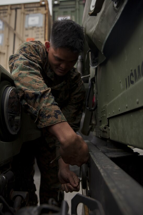 Cpl. Richard Caasi, a motor transport Marine with Battalion Landing Team, 2nd Battalion, 5th Marines, 31st Marine Expeditionary Unit, attaches a convoy placard to a Humvee at Camp Hansen, Okinawa, Japan, Feb. 28, 2017. The Marines and Sailors of the 31st MEU are making final preparations before embarking as a part of the Bonhomme Richard Amphibious Ready Group. As the Marine Corps' only continuously forward-deployed unit, the 31st MEU air-ground-logistics team provides a flexible force, ready to perform a wide range of military operations, from limited combat to humanitarian assistance operations, throughout the Indo-Asia Pacific region. (U.S. Marine Corps photo by Lance Cpl. Amy Phan) 