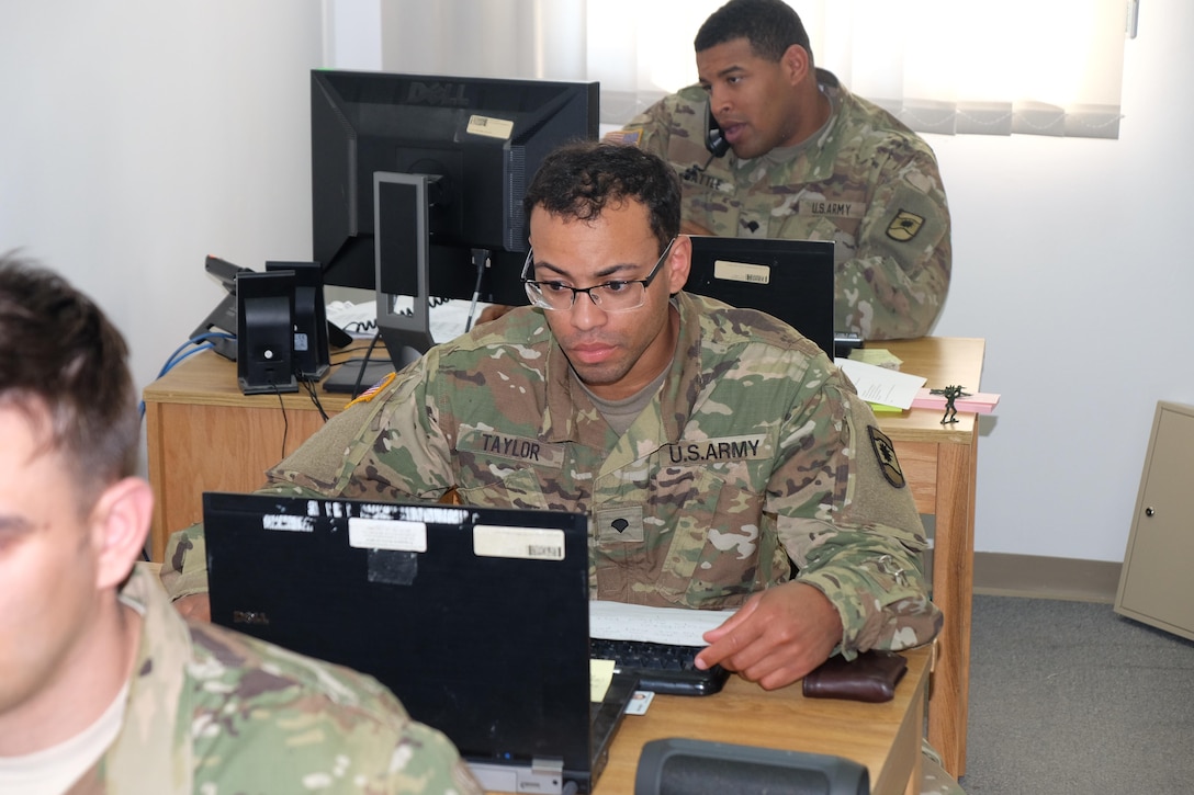 Left to right, Soldiers from the 7th Mission Support Command’s 793rd Movement Control Team, Spc. James Taylor, movement specialist and Spc. William Battle, movement specialist, work on movement coordination operations and planning, Mar. 29, 2017.