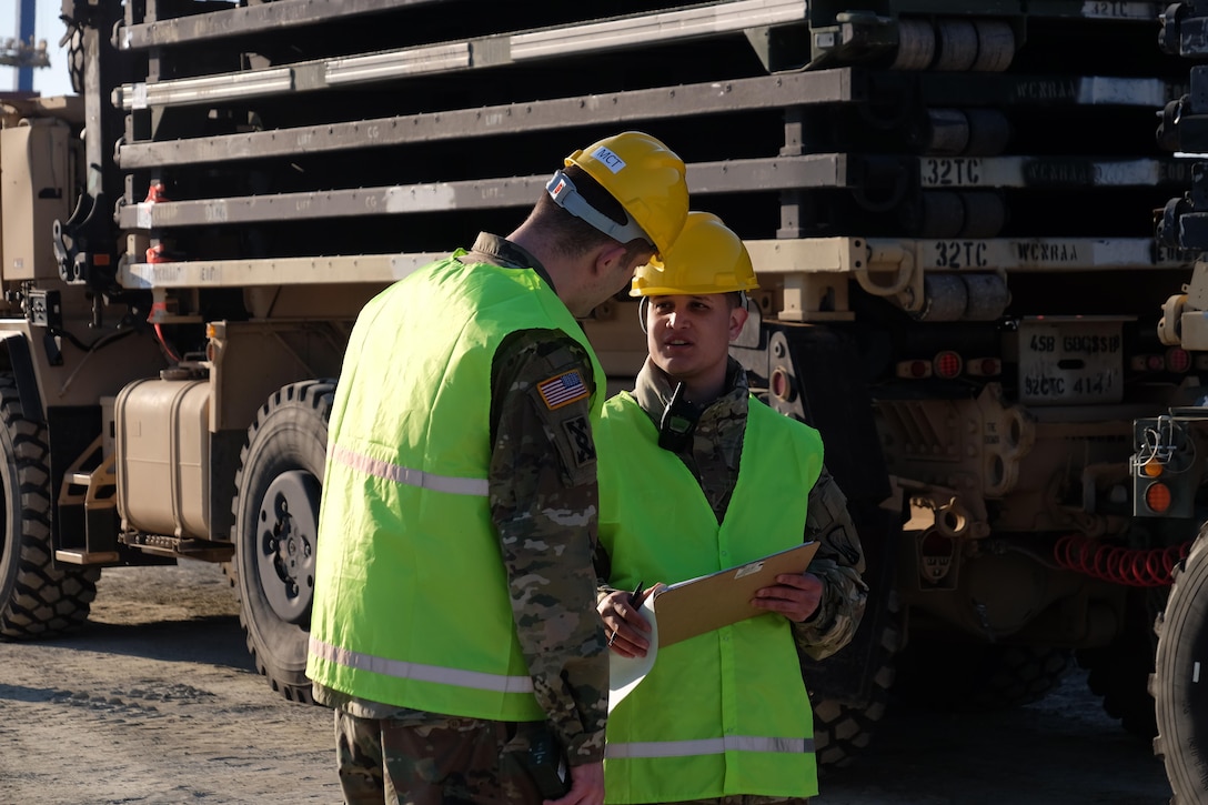 Left, the 7th Mission Support Command’s Sgt. Alexander Lapotsky a movement noncommissioned officer with the 793rd Movement Control Team, and Sgt. Francisco Casanova a port operations NCO from the 39th Transportation Battalion (MC), 16th Sustainment Brigade, 21st Theater Sustainment Command conducts port disembarkation operations for military vehicles, equipment download and convoy staging with Soldiers from the 497th Combat Sustainment Support Battalion, the 39th Transportation Battalion (MC), 16th Sustainment Brigade, 21st Theater Sustainment Command, 1st Inland Cargo Company, 18th Combat Sustainment Support Battalion, 405th Army Field Support Brigade, 32nd Composite Truck Company and the 839th Transportation Battalion from the Surface Deployment and Distribution Command as part of Operation Atlantic Resolve March 31, 2017.  