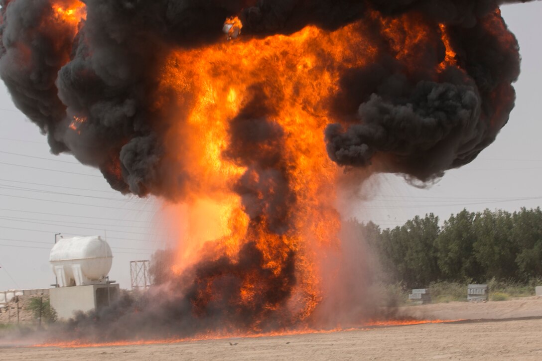 An explosion simulating a bomb detonating signals the beginning of a scenario where special operations forces from the U.S., Qatar, Kuwait, Saudi Arabia, and United Arab Emirates take a Kuwaiti farm back from the opposing force.  Soldiers from Company B, 3rd Battalion, 8th Cavalry Regiment, 3rd Armord Brigade Combat Team, 1st Cavalry Division played the opposing force for a joint training exercise between U.S. special operations forces and SOF elements from Qatar, Kuwait, Saudi Arabia, and United Arab Emirates. (U.S. Army photo by Staff Sgt. Leah R. Kilpatrick, 3rd Armored Brigade Combat Team Public Affairs Office, 1st Cavalry Division (released)