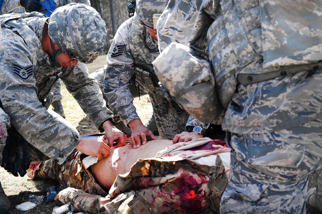 Airmen practice medical aid to a mock casualty during the tactical combat casualty care exercise at the Ground Combat Readiness Training Center’s Security Operations Course at Ramstein Air Base, Germany, March 30, 2017. Air Force photo by Senior Airman Tryphena Mayhugh