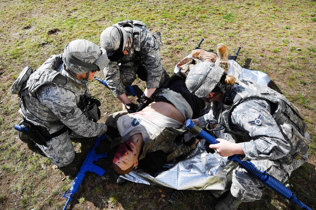 Airmen practice medical aid with a mock casualty during the tactical combat casualty care exercise at the Ground Combat Readiness Training Center’s Security Operations Course at Ramstein Air Base, Germany, March 30, 2017. Air Force photo by Senior Airman Tryphena Mayhugh