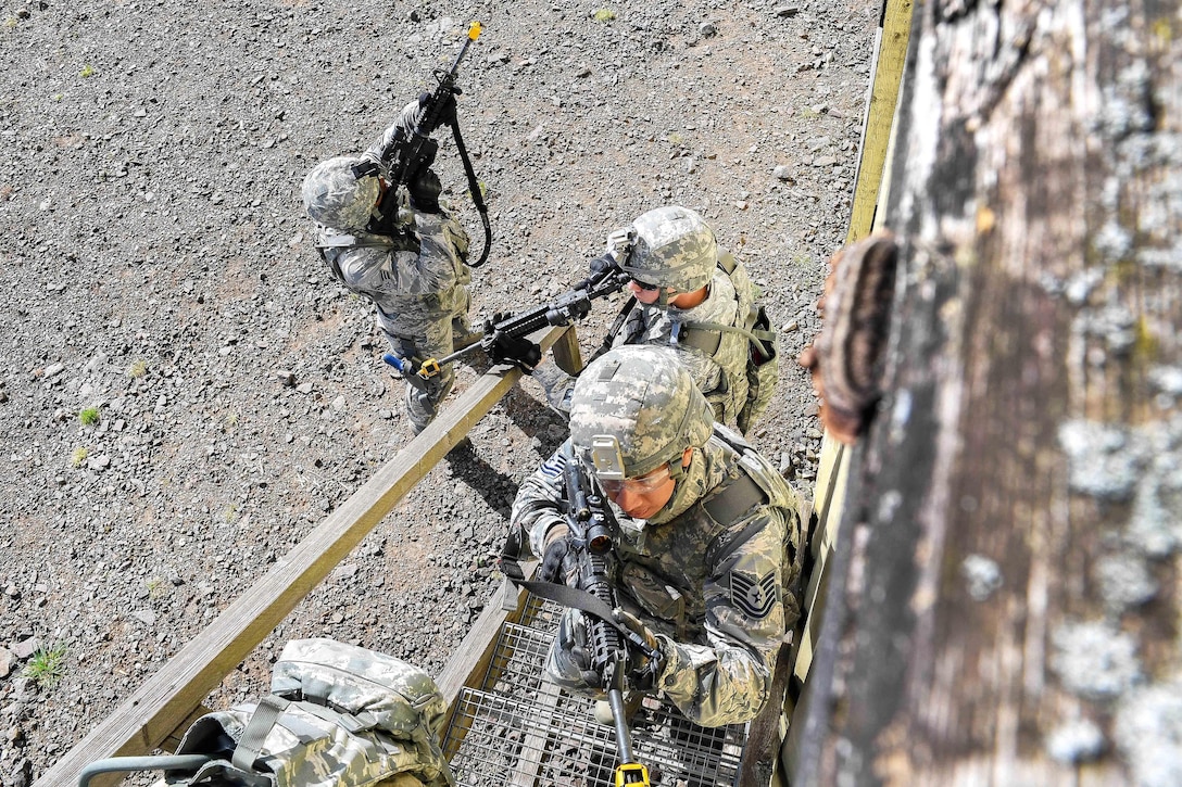 Air Force Tech. Sgt. Christian Gomez, foreground, and team members climb stairs to search the top floor of a building during an urban operations training course at U.S. Army Garrison Baumholder, Germany, April 4, 2017. Gomez is assigned to the 569th U.S. Forces Police Squadron Bravo Flight. 