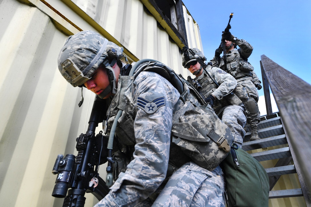 Air Force Senior Airman Rachel Newell, foreground, and team members move down stairs after searching a building during an urban operations training course at U.S. Army Garrison Baumholder, Germany, April 4, 2017. Newell assigned to the 569th U.S. Forces Police Squadron. Air Force photo by Senior Airman Tryphena Mayhugh