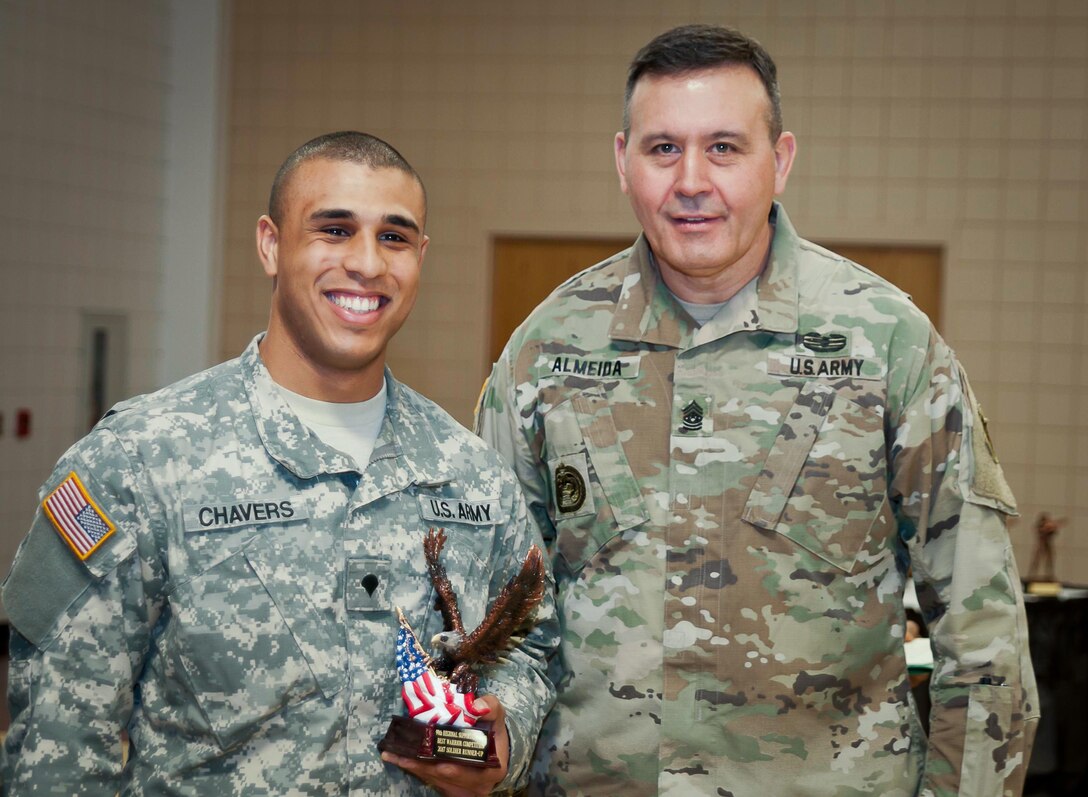 Command Sgt. Maj. Arlindo Almeida, Command Sergeant Major, 99th Regional Support command (right) poses for a photo with Spc. Aaron Chavers, 198th Army Band, after receiving a trophy during a ceremony at Fort Devens Massachusetts, 6 April, 2017. Chavers received the award for finishing first place in the Junior Enlisted category of the 99th Regional Support Command's 2017 Best Warrior Competition that took place here 2-6 April and will advance to compete in the U.S. Army Reserve Command’s Best Warrior Competition slated for June.