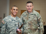 Command Sgt. Maj. Arlindo Almeida, Command Sergeant Major, 99th Regional Support command (right) poses for a photo with Spc. Aaron Chavers, 198th Army Band, after receiving a trophy during a ceremony at Fort Devens Massachusetts, 6 April, 2017. Chavers received the award for finishing first place in the Junior Enlisted category of the 99th Regional Support Command's 2017 Best Warrior Competition that took place here 2-6 April and will advance to compete in the U.S. Army Reserve Command’s Best Warrior Competition slated for June.