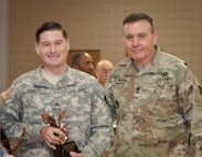Command Sgt. Maj. Arlindo Almeida, Command Sergeant Major, 99th Regional Support command (right) poses for a photo with Sgt. Curtis Presley, 380th Army Band, after receiving a trophy during a ceremony at Fort Devens Massachusetts, 6 April, 2017. Presley received the award for finishing first place in the Noncomissioned Officer category of the 99th Regional Support Command's 2017 Best Warrior Competition that took place here 2-6 April and will advance to compete in the U.S. Army Reserve Command’s Best Warrior Competition slated for June.