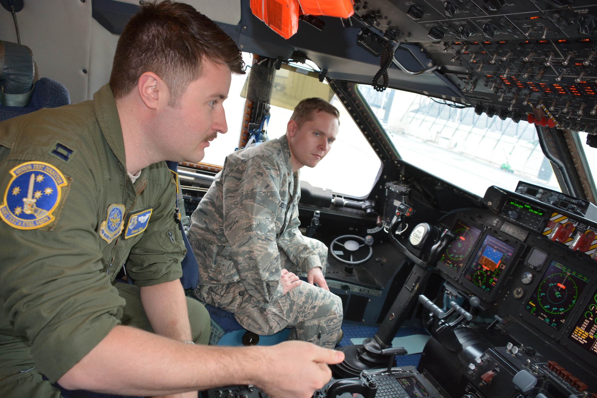 U.S. Air Force Capt. Ryan Tell, AMCTES senior test director, conducts cyber-security checks on a C-5M aircraft. The training is designed to prepare aircrew for cyber-attacks on the aircraft by simulating an opportunity to counter a simulated cyber-threat.