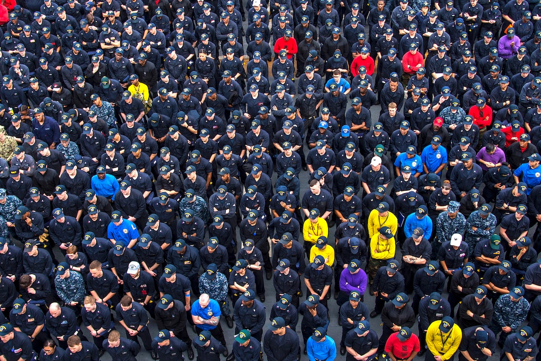 Sailors and Marines stand in formation during an all-hands call on the flight deck of the USS Bonhomme Richard in the East China Sea, April 9, 2017, as the amphibious assault ship patrols in the Indo-Asia-Pacific region. Navy photo by Petty Officer 3rd Class Jeanette Mullinax