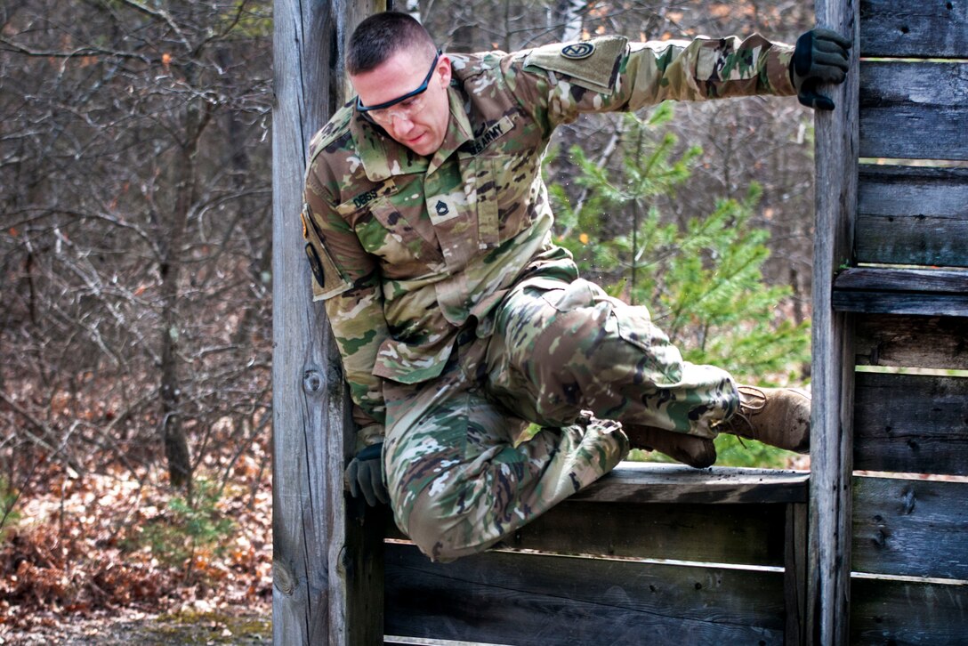Army Reserve Sgt. 1st Class Joshua Deiss climbs through a wooden window obstacle during the Best Warrior Competition at Fort Devens, Mass., April 5, 2017. Army photo by Staff Sgt. Timothy Koster