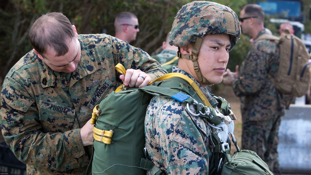 Gunnery Sgt. Joseph A. Purdy tightens the straps on a parachute before an air-drop delivery jump at Marine Corps Auxiliary Landing Field Bogue, N.C., March 27, 2017. The training was part of field exercise Bold Bronco 17, which demonstrated the units ability to provide transportation support via air, land or sea. Purdy is a jumpmaster with 2nd Transportation Support Battalion, 2nd Marine Logistics Group. 