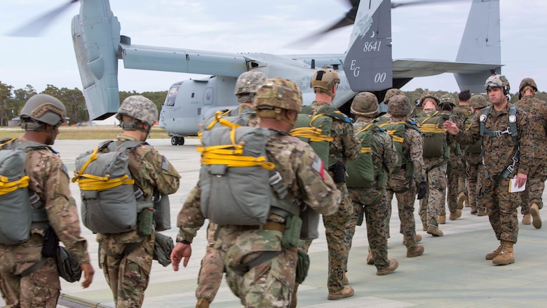 Marines and soldiers board an MV-22B Osprey during an air-drop delivery jump exercise at Marine Corps Auxiliary Landing Field Bogue, N.C., March 27, 2017. The training was part of field exercise Bold Bronco 17, which allowed the Marines to demonstrate their transportation support skills in various environments. The Marines are with 2nd Transportation Support Battalion, 2nd Marine Logistics Group and the Soldiers are with 647th Quartermaster Company, 3rd Expeditionary Sustainment Command. 