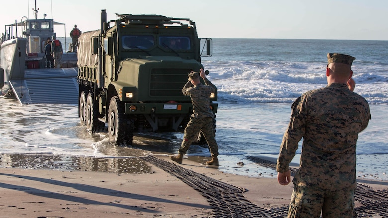 Marines guide a vehicle onto a Landing Craft Mechanized-8 boat during a beach operations group exercise at Onslow Beach, N.C., March 30, 2017. The operation was part of field exercise Bold Bronco 17 and allowed Marines to conduct amphibious training with the Army. The Marines are landing support specialists with Combat Logistics Battalion 8, 2nd Marine Logistics Group. 