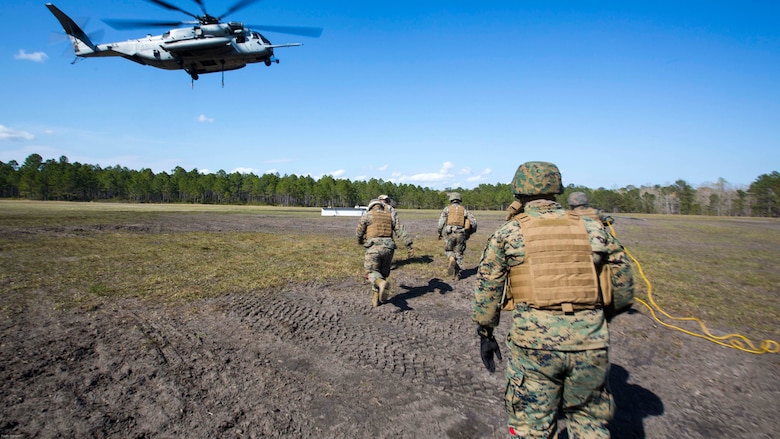 Marines run toward a CH-53E Super Stallion to conduct Helicopter Support Team operations at Camp Lejeune, N.C., March 30, 2017. The training helped the Marines hone their skills in the transportation of gear via air assets and was part of field exercise Bold Bronco 17. The Marines are landing support specialist with 2nd Transportation Support Battalion, 2nd Marine Logistics Group. 