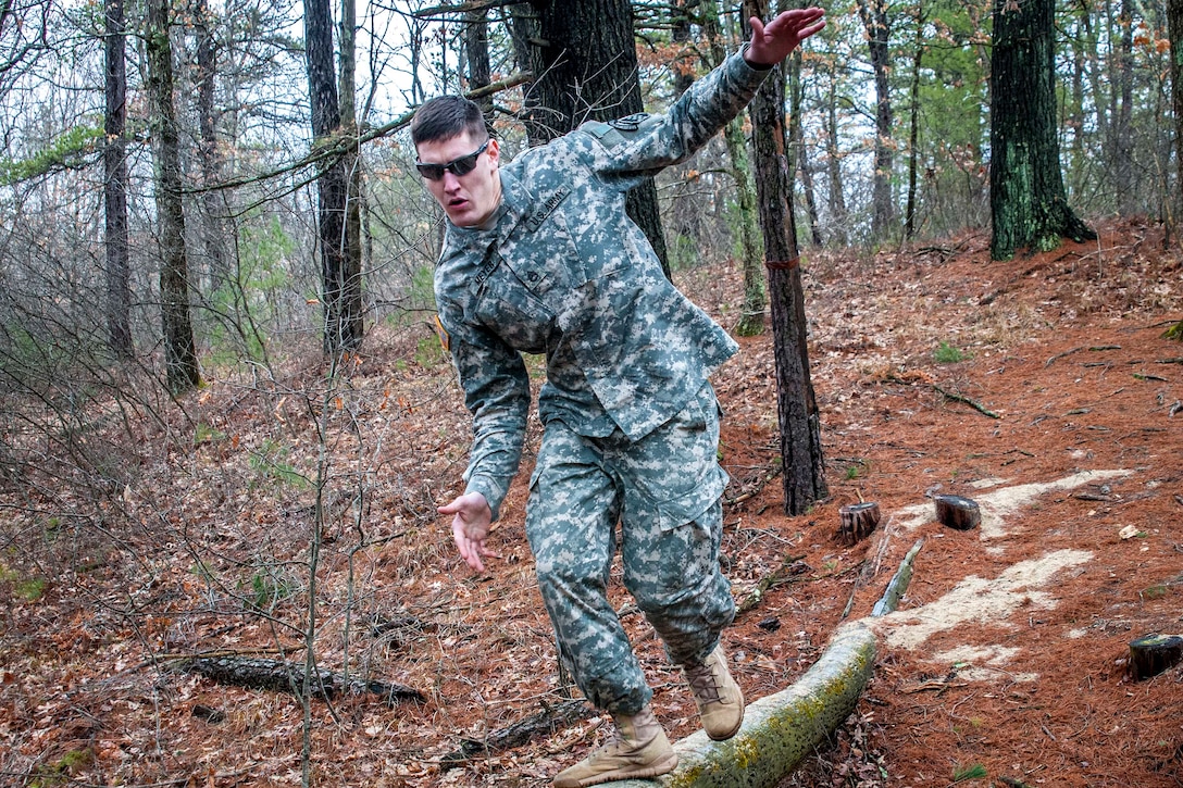 Army Reserve Sgt. Joshua D. Meyer balances his way across a log obstacle during the Best Warrior Competition at Fort Devens, Mass., April 5, 2017. Army photo by Staff Sgt. Timothy Koster