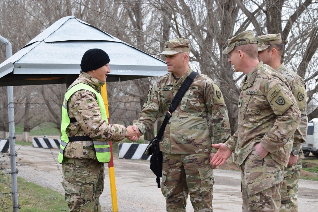 Lt. Col. Joseph Gardner, commander of the Kentucky National Guard 149th Military Engagement Team, center, shakes hands with one of the Kazakhstani instructors from the Kazakhstan Peacekeeping Battalion during his visit to Steppe Eagle Koktem Apr. 5, 2017, at Illisky Training Center, Kazakhstan.