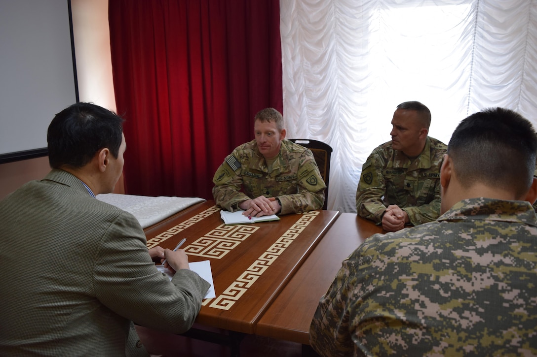 Lt. Col. Kent Cavallini, deputy commander of the Kentucky National Guard 149th Military Engagement Team, center, and Lt. Col. Joseph Gardner, commander of the 149th MET, meet with officials from the Presidential Office of Kazakhstan Apr. 5, 2017, at Illisky Training Center, Kazakhstan, to discuss observations and recommendations for the Kazakhstan Peacekeeping Battalion.