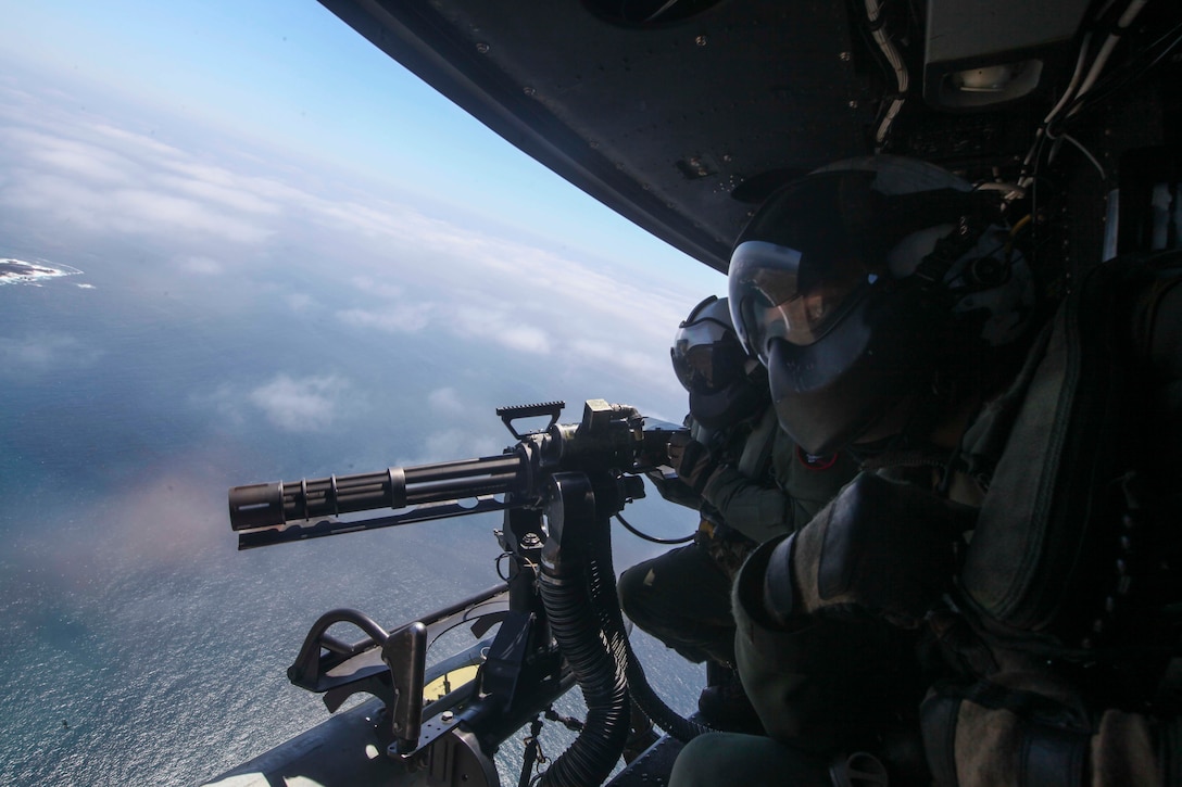 Sgt. George Hamil, an aerial observer, and Sgt. Zachary Zimberg, a crewcheif with Marine Medium Tiltrotor Squadron 161, 15th Marine Expeditionary Unit, uses direct fire to assault targets on the objective during Amphibious Squadron-Marine Expeditionary Unit Integration, April 5, 2017. Hamil manned the GAU-17/A minigun and Zimberg provided oversight aboard a UH-1Y Huey. PMINT is a vital exercise used to hone skills and tactics in order to enhance the MEU’s operational abilities to be flexible and responsive.