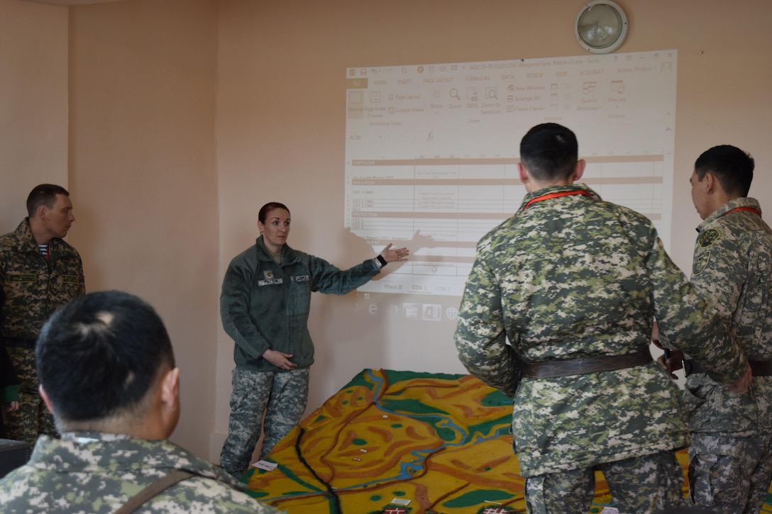 Maj. Ashley Philbin, Arizona National Guard, points out a planning factor during a military-to-military engagement for battalion staff at Steppe Eagle Koktem Apr. 4, 2017, at Illisky Training Center, Kazakhstan.