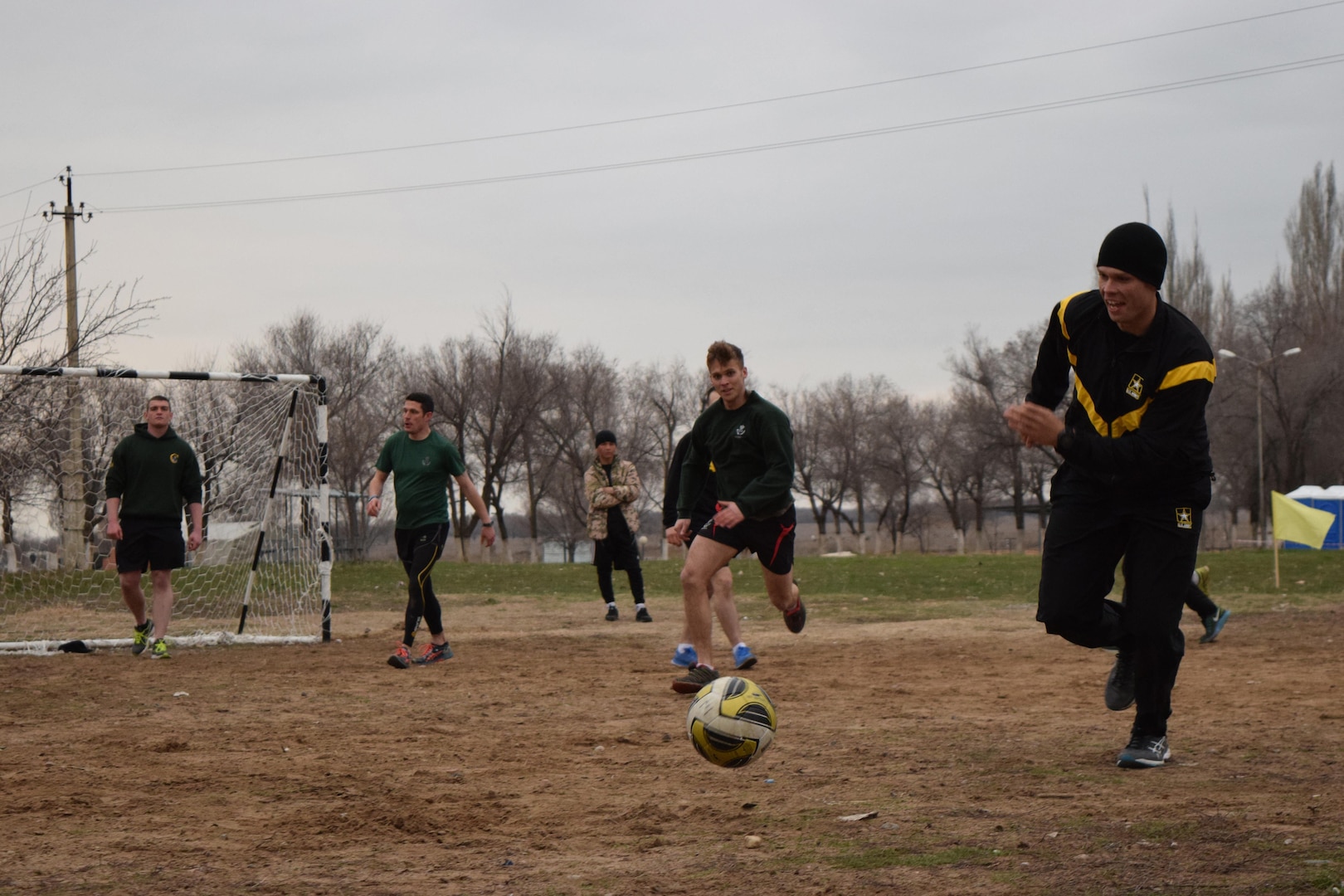 An Arizona National Guard Soldier races for the ball during a game of soccer against the U.K. soldiers with 1st Battalion, The Rifles, 160 Brigade, Apr. 2, 2017, at Illisky Training Center, Kazakhstan. The soldiers are participating in Steppe Eagle Koktem, phase one of the multinational Steppe Eagle Exercise.