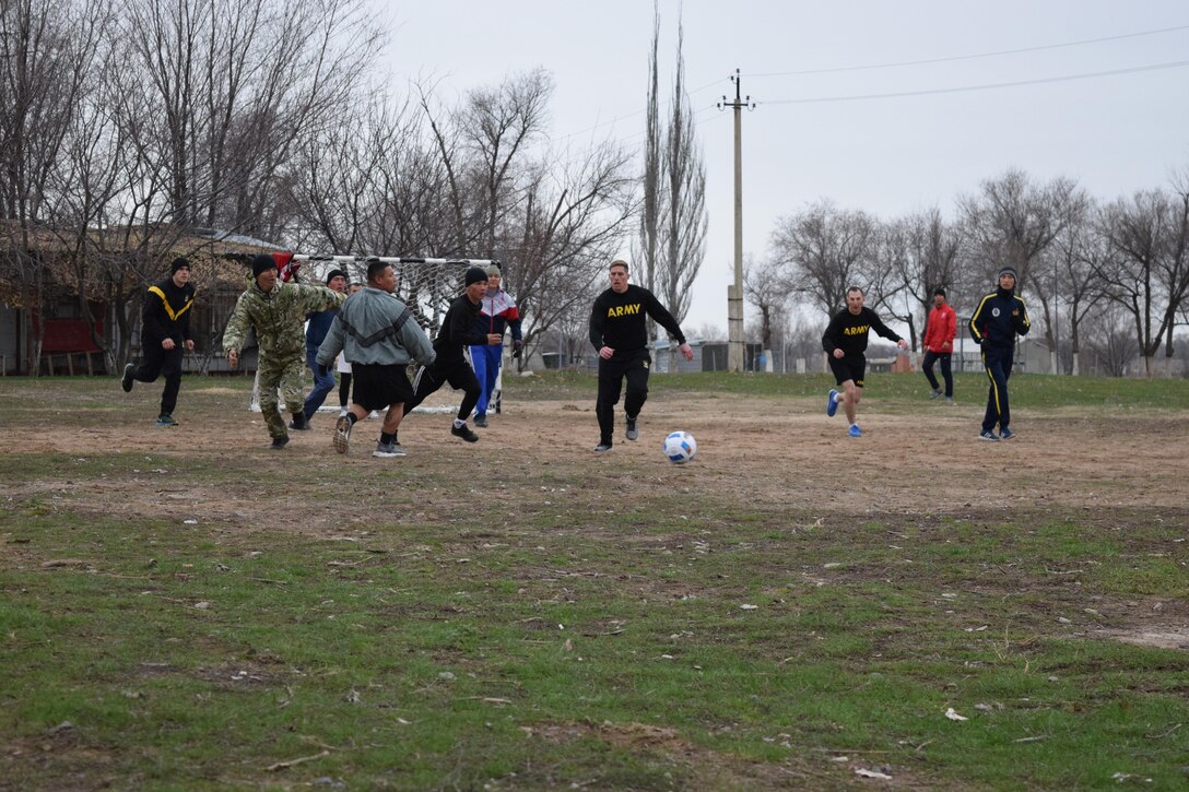 Kazakhstani and U.S. Army Soldiers race toward the soccer ball during a team-building game Apr. 2, 2017, as part of Steppe Eagle Koktem at Illisky Training Center, Kazakhstan. Koktem is a series of military-to-military engagements that lead into Exercise Steppe Eagle later in the year.