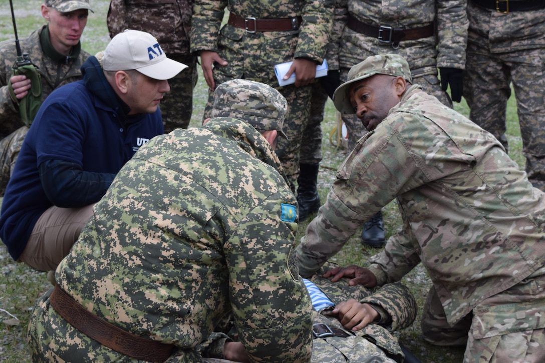 Master Sgt. Kevin Walker, 3rd Medical Command (Deployment Support), shows a Kazakhstani medic how the U.S. Army assesses a patient for injury during Steppe Eagle Koktem Apr. 2, 2017, at Illisky Training Center, Kazakhstan. The medical information exchange is one of many military-to-military engagements that take place during this first phase of Exercise Steppe Eagle.