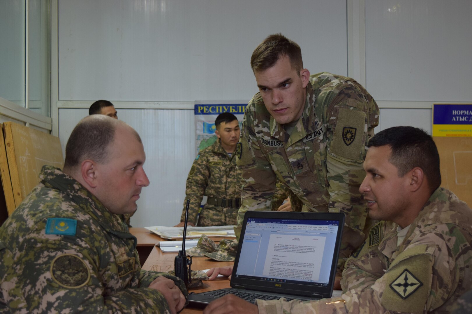 Two U.S. Army Soldiers and a Kazakhstani Soldier with the Kazakhstan Peacekeeping Battalion Sustainment Company develop a company operations order Apr. 2, 2017, that will be used for the rest of Exercise Steppe Eagle. Exercise Steppe Eagle 17 takes place in Kazakhstan beginning July 22, 2017, and focuses on multinational Peacekeeping and Peace Support Operations.
