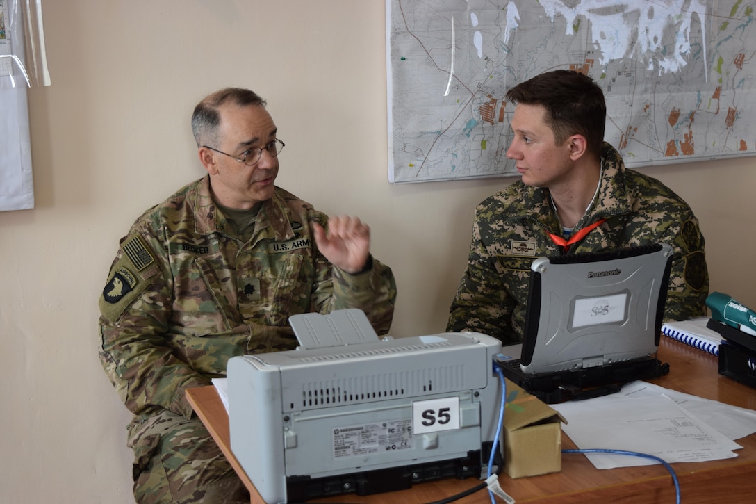 Lt. Col. James Becker, 352nd Civil Affairs Command, discusses civil military operations with a Kazakhstani soldier of the Kazakhstan Peacekeeping Battalion during day two of Steppe Eagle Koktem, Apr. 2, 2017, at Illisky Training Center, Kazakhstan.