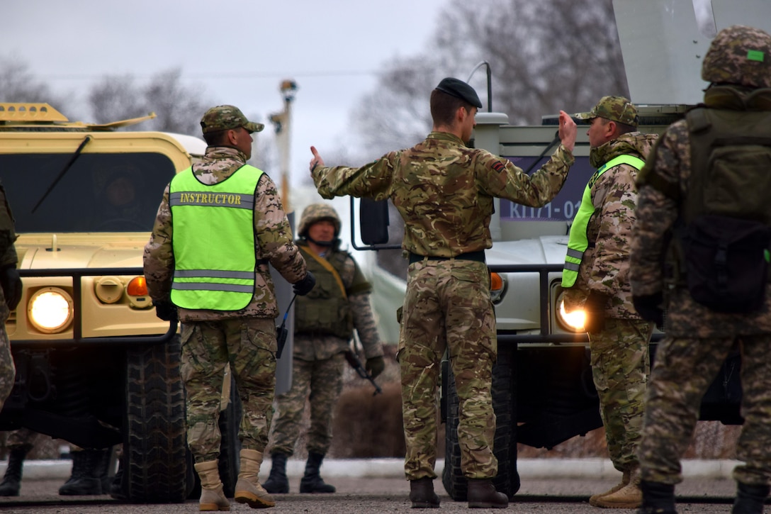 A U.K. Soldier with the British Army's 1st Battalion, The Rifles, 160 Brigade, discusses options for using vehicles during crowd control with a Kazakhstani instructor from the Kazakhstan Peacekeeping Battalion during Steppe Eagle Koktem, Apr. 3, 2017, at Illisky Training Center, Kazakhstan.