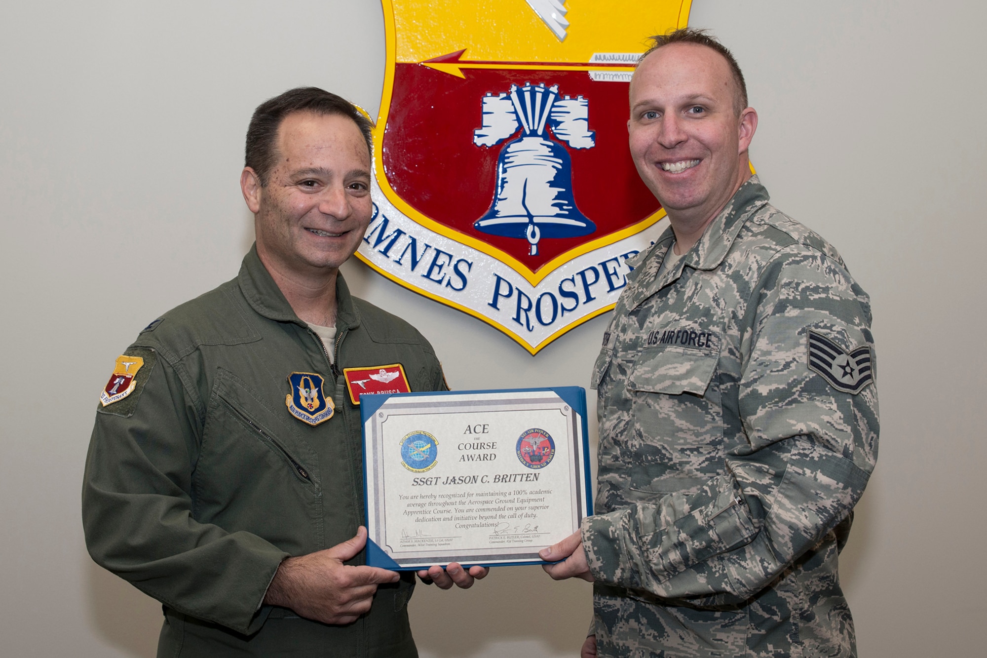 U.S. Air Force Reserve Col. Anthony Brusca, interim commander for the 913th Airlift Group and Staff Sgt. Jason C. Britten, aerospace ground equipment apprentice, 913th Maintenance Squadron, pose for a photo at Little Rock Air Force Base, Ark., April 5, 2017. Britten received the prestigious ACE Award March 20, 2017, while training at Sheppard AFB, Texas. The ACE award is earned by maintaining a perfect 100 percent on all tests and evaluations through an entire course. (U.S. Air Force photo by Master Sgt. Jeff Walston/Released)